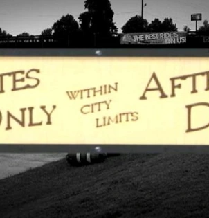 A sign that says "Whites only within city limits after dark"